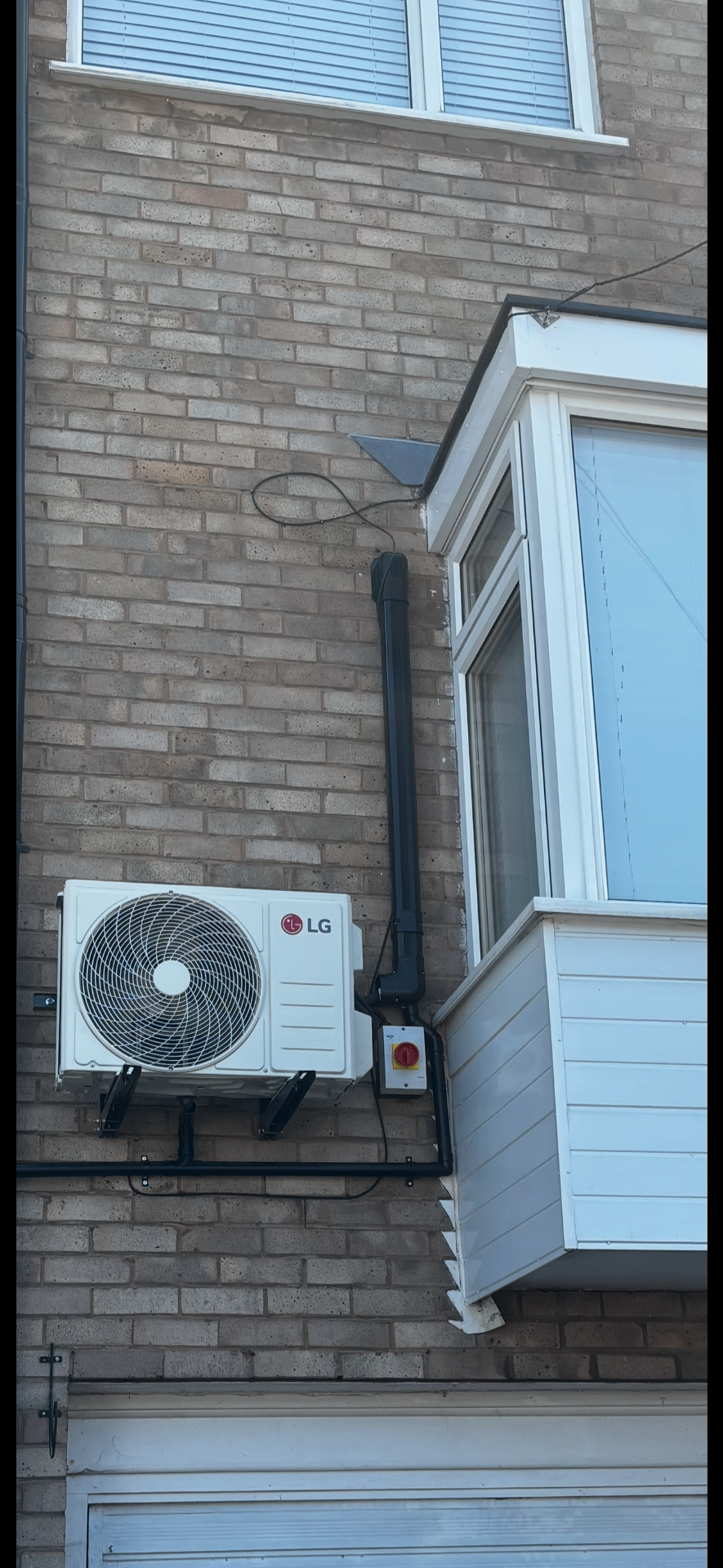 LG outdoor condenser unit neatly wall-mounted on a Halesowen home — the same install standard used on Evesham jobs